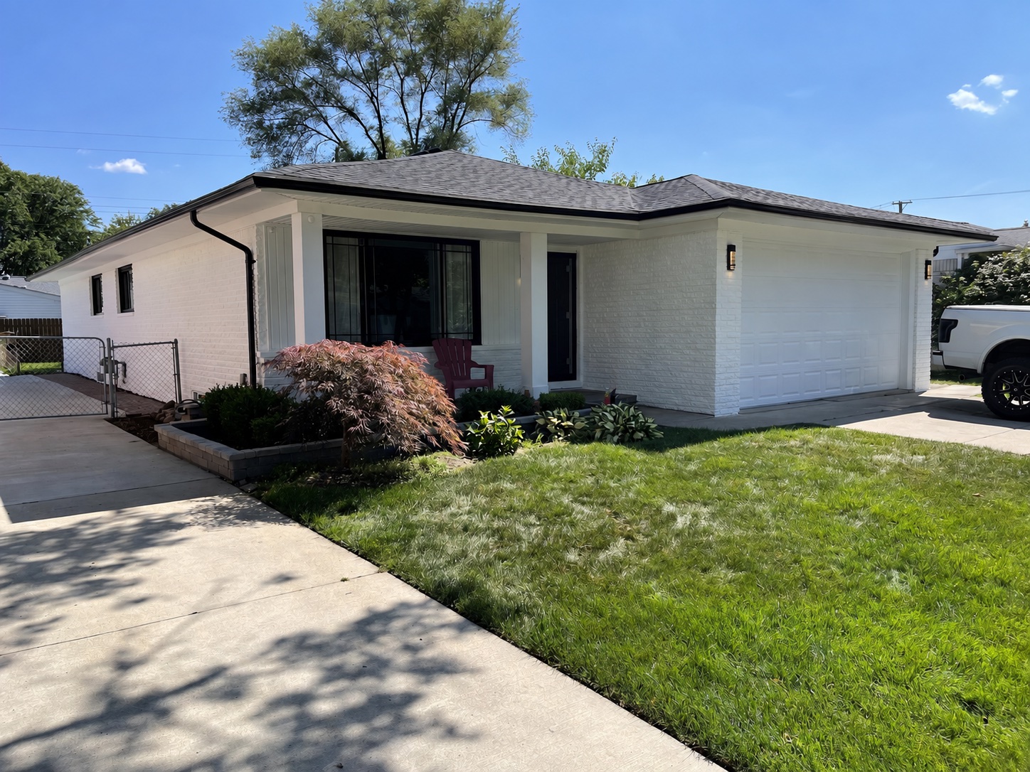 Completed Metro Detroit exterior painting project with white brick and black trim